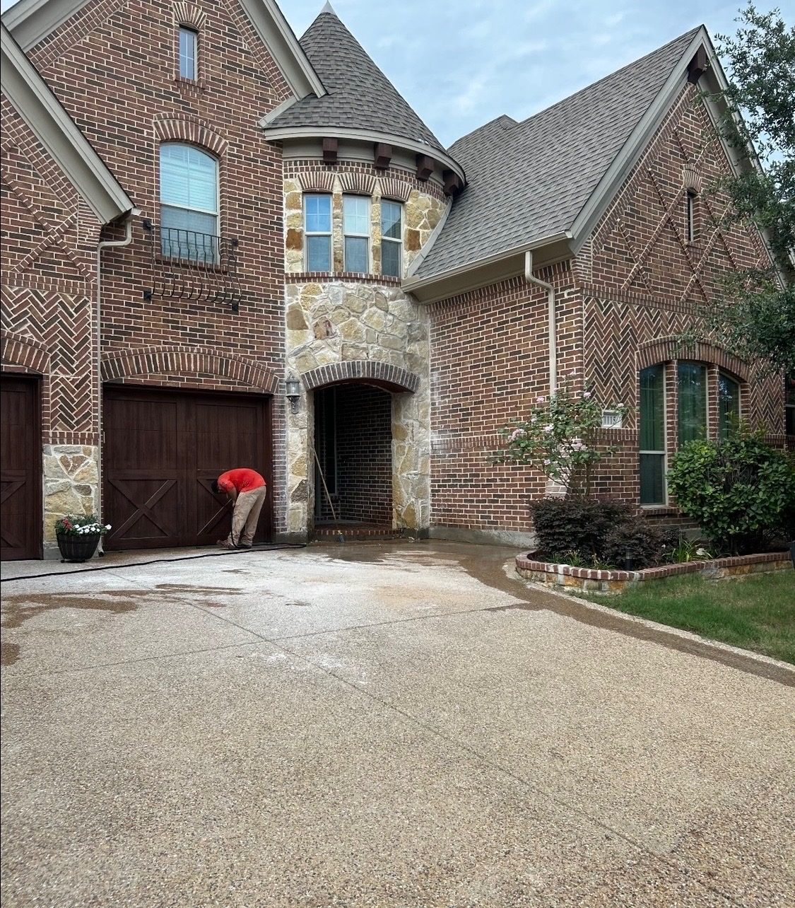 The finished brick and stone house front, with the repaired stone arch over the entry