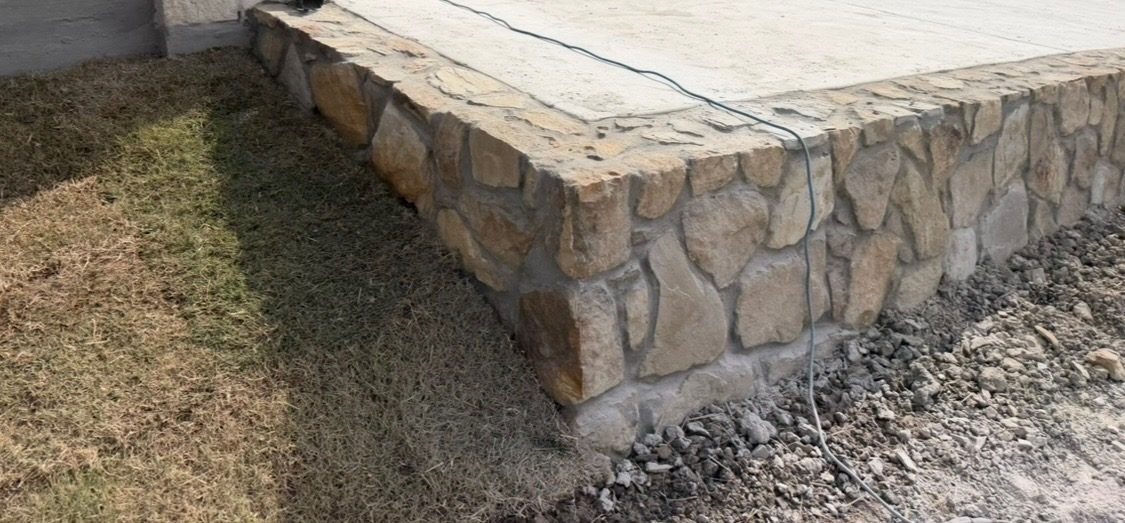 Close view of the stone retaining wall where it turns the corner of the slab